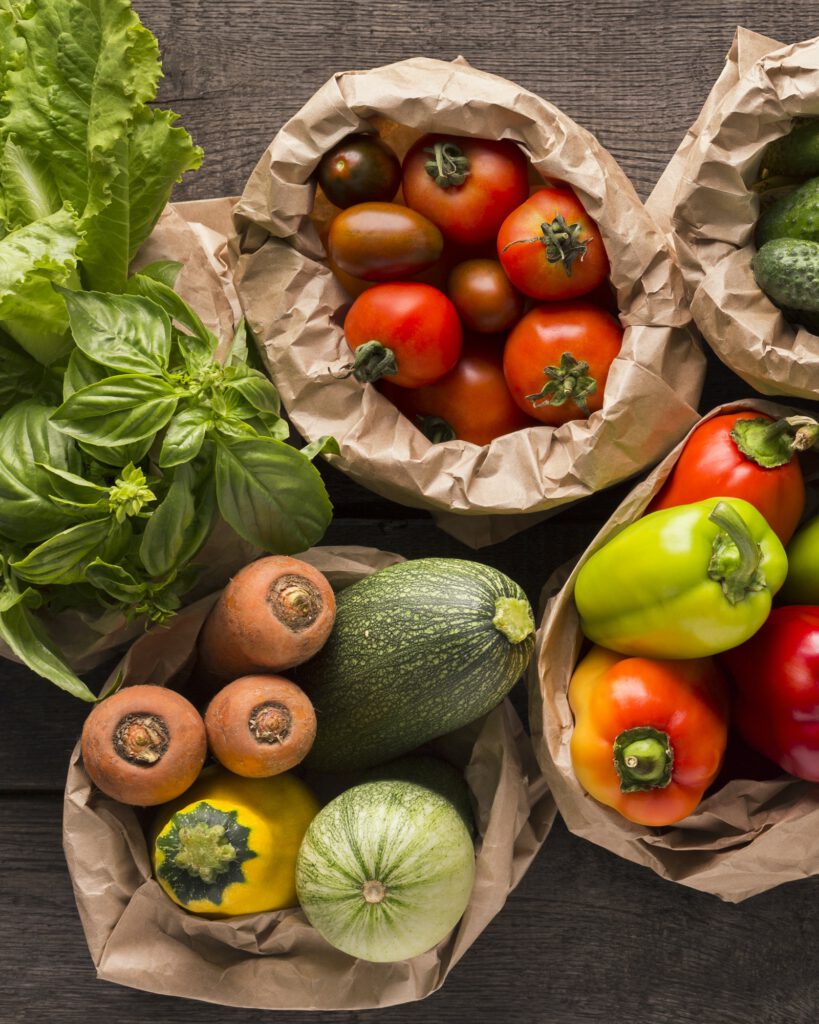 Close up of fresh eco vegetables in coton bags on wood