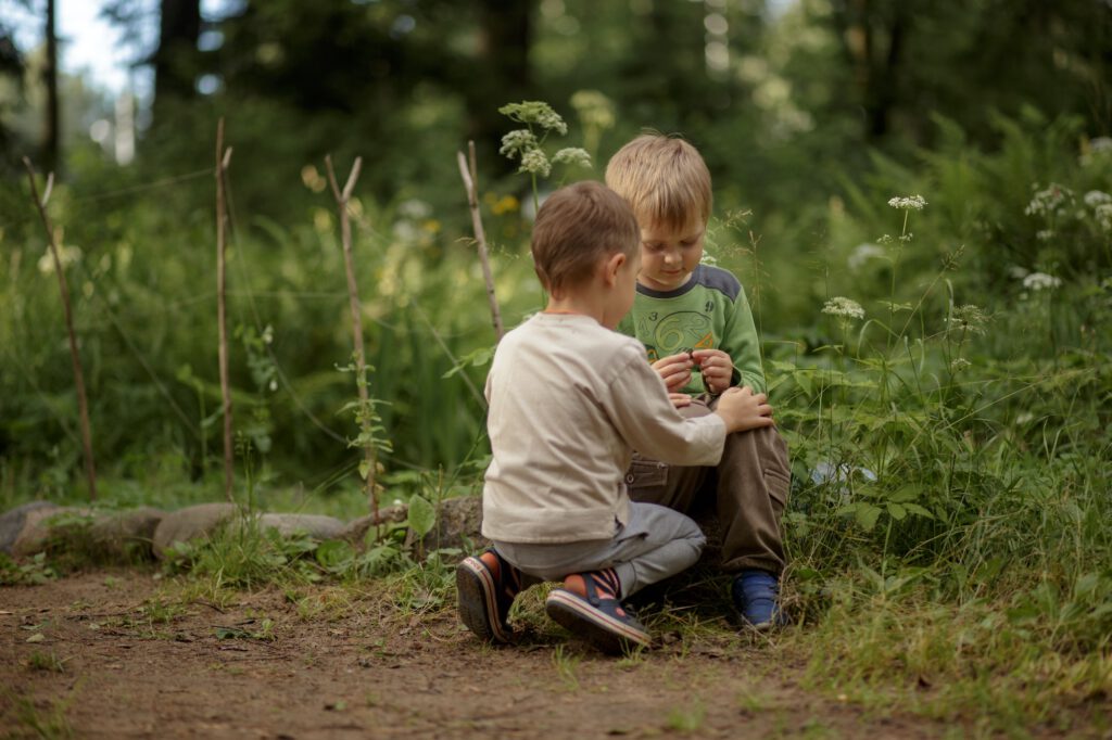 Kids exploring nature holding a butterfly
